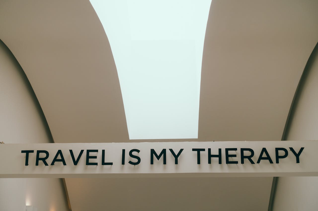 A motivational travel quote displayed in a minimalist interior setting.