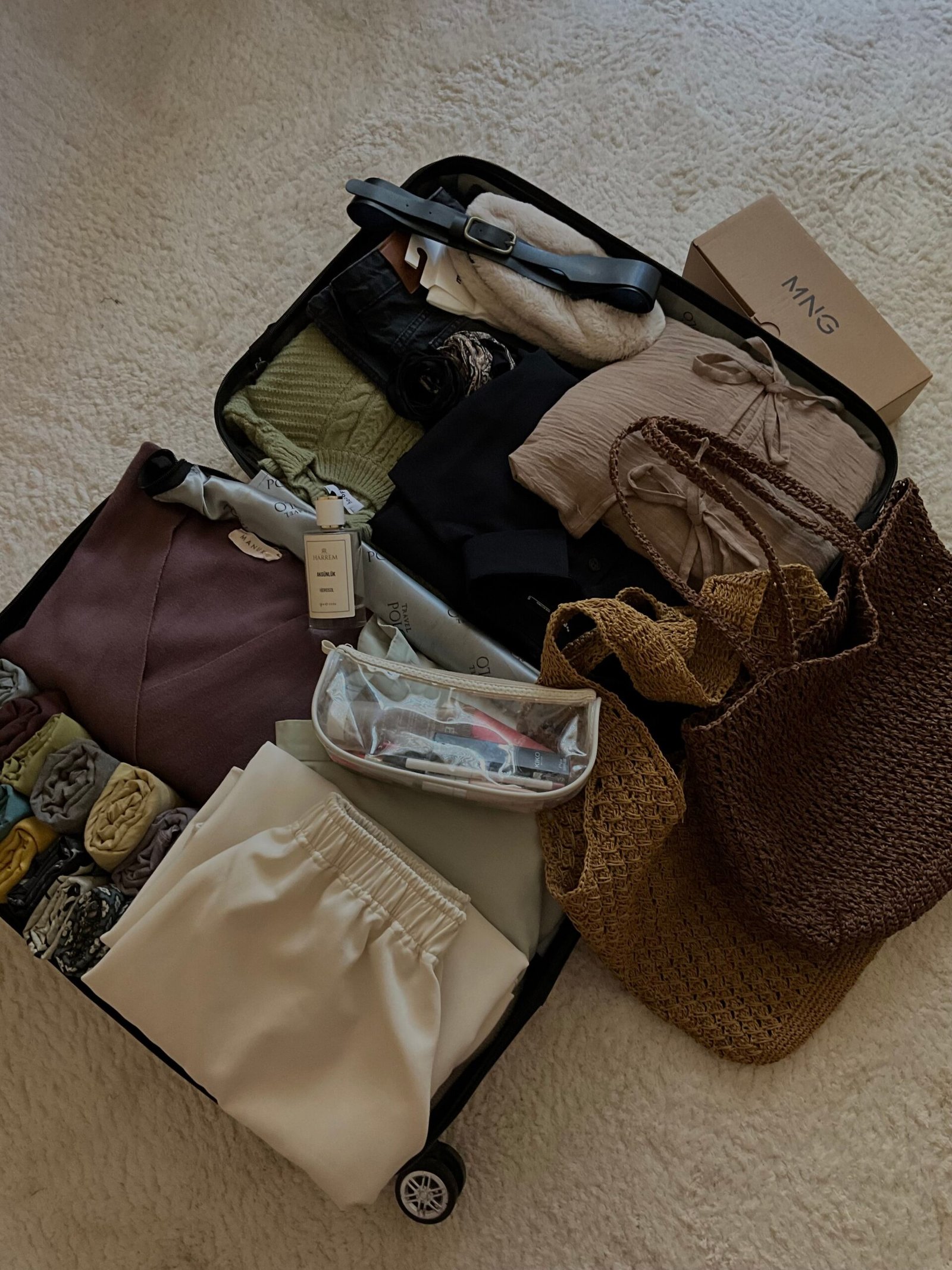 What I Pack for Every Trip (Carry-On Only) A suitcase neatly packed with clothes, accessories, and travel essentials for a chic vacation.